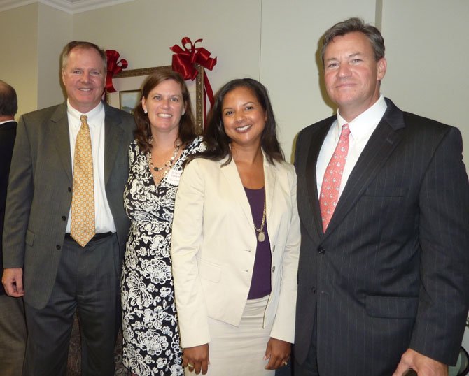 Vince Keegan, Sharon Keegan, branch manager Kellye Curtis Clarke and Tony DeVol celebrate the Sept. 21 opening of Hometown Title & Escrow's new offices at Courthouse Square in Old Town.
