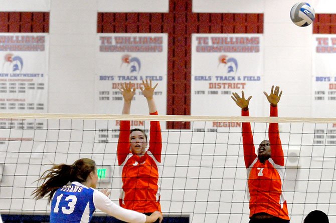 West Springfield middle blockers Destini Davis (7) and Savannah Schutzmeister leap to block against T.C. Williams’ Kate Whitmire on Oct. 2.