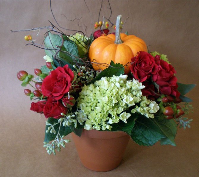 Pumpkins and other fall produce are a popular addition to autumn floral arrangements.
