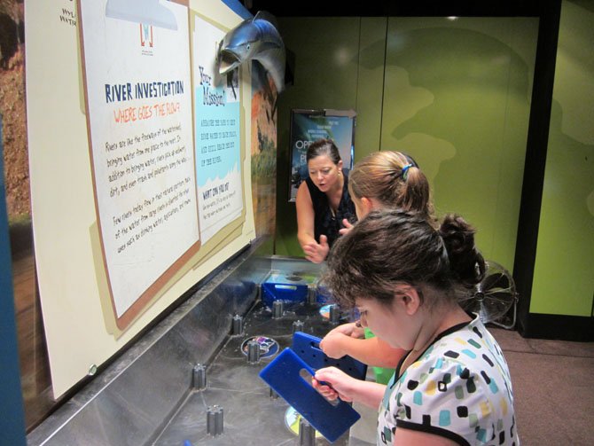 Volunteer Christina Wenks shows water distribution.