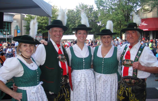 Janet Nagler, Charles Volkman, Claudia Fochios and Angela Kummel perform Bavarian dances in traditional costumes during the Capital City Brewing Company Oktoberfest at the Shirlington Village. 
