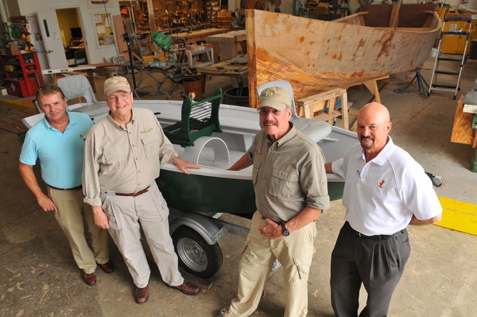 Alexandria Seaport Foundation executive director Kent Barnekov and foundation board member Rex Wagner turned over a repaired fly fishing boat to Healing Waters National Capital Regional Coordinator George Gaines and Roger Carlson on Oct. 4.

