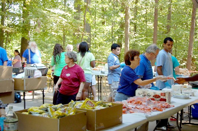 Hot dogs are being prepared as other items are being served to over 300 guests.