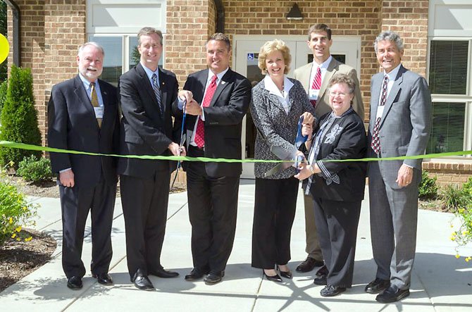 (From left) Jim Chandler, director of LIHTC Credits, VHDA; Delegate David Bulova (D-37); Mayor Scott Silverthorne, City of Fairfax; Jane Henderson, president and CEO, Virginia Community Capital; Stephen Smith, vice president, Enterprise Community Investment, Inc.; Wilma Huff, West Wood Oaks resident; and J. Michael Pitchford, president, Community Preservation and Development Corporation, celebrate the completion of the $6.7 million green renovation of the West Wood Oaks apartments in Fairfax.
