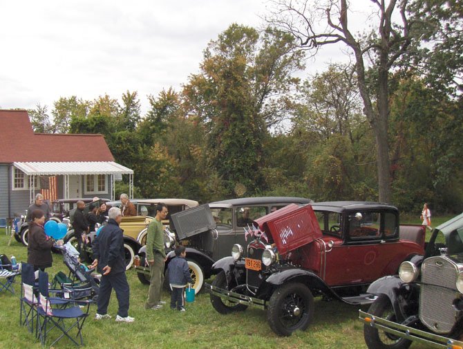 Looking at antique cars near a historic home during last year’s Centreville Day. 
