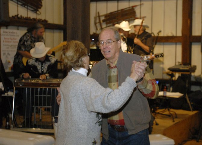 George and Jane Newman enjoy the music of Bennie Potter and Western Electric while attending the 7th Annual Barn Dance sponsored by the Great Falls Optimist Club.