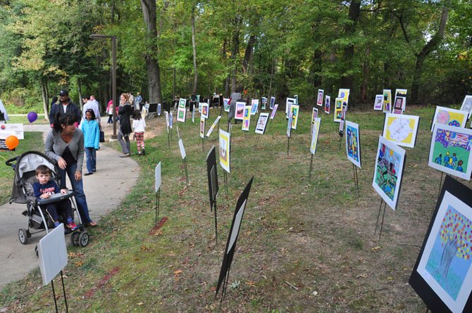 Visitors to the McLean Project for the Arts explore the Children’s’ Art Walk, made up of local students’ work at McLean Central Park Sunday, Oct. 14. 