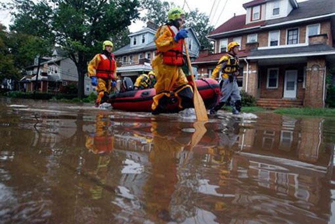 Firefighters pull rescue boats for Huntington residents whose homes were flooded during Tropical Storm Lee.
