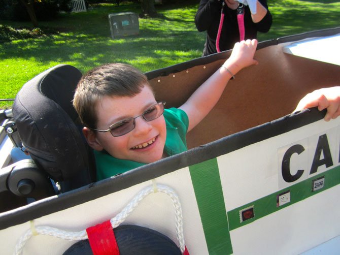 Twelve-year-old Sean Fennelly testing his new “boat-costume”; it is custom-designed and hand-crafted for attachment to Sean’s wheelchair.