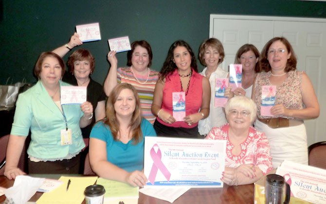 Women Mean Business members, shown prior to last year's silent auction to raise money for the city's breast cancer surgical fund, have decided to disband after 12 years.
