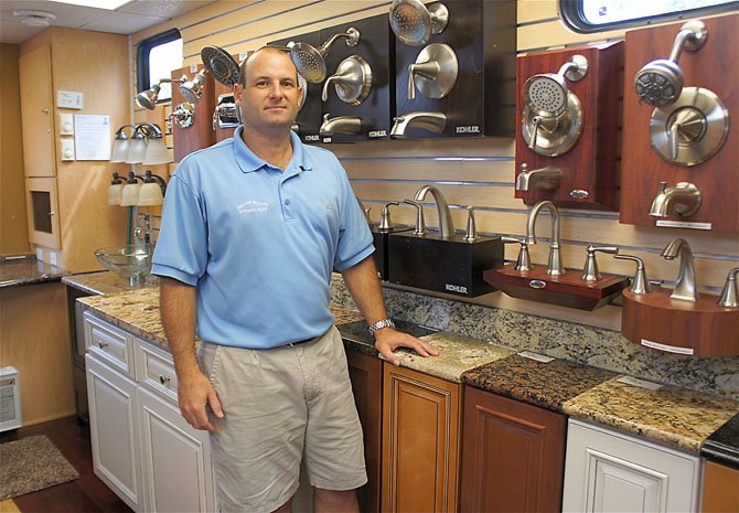 Jeff Pregman, general manager of Two Poor Teachers, shows off just a few of the items on display in the company's mobile showroom.