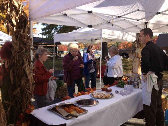 John Conway, The Old Brogue's master chef, looks on as Farmers Market visitors enjoy his freshly prepared creations.