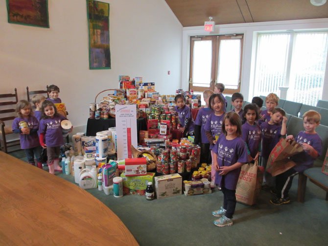 Preschoolers at F. B. Meekins Preschool fill bags with food and non-perishables for delivery to the Our Daily Bread storage pantry at CubeSmart in Vienna. The preschool partnered with Emmaus United Church of Christ for collection.