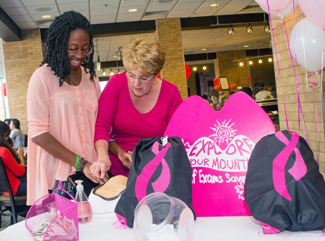 Diane White, director of the Marymount University Student Health Center, teaches Mashawna Kimble how to do a breast self-exam.
