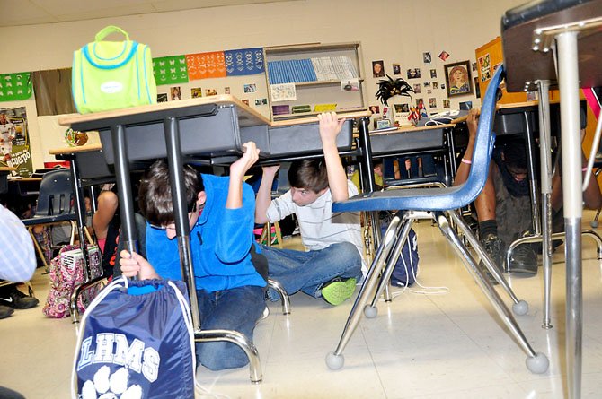 Langston Hughes Middle School students participate in the U.S. Geological Survey’s ShakeOut drills Thursday, Oct. 18. 