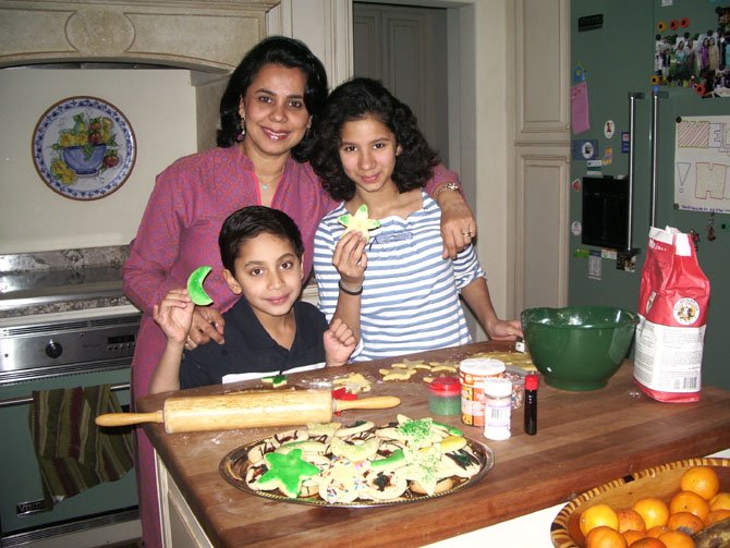 Salma Hasan Ali, Saanya Ali, 16, and Zayd Ali, 10, bake moon and star cookies by the dozen, for neighbors, classmates and friends.
