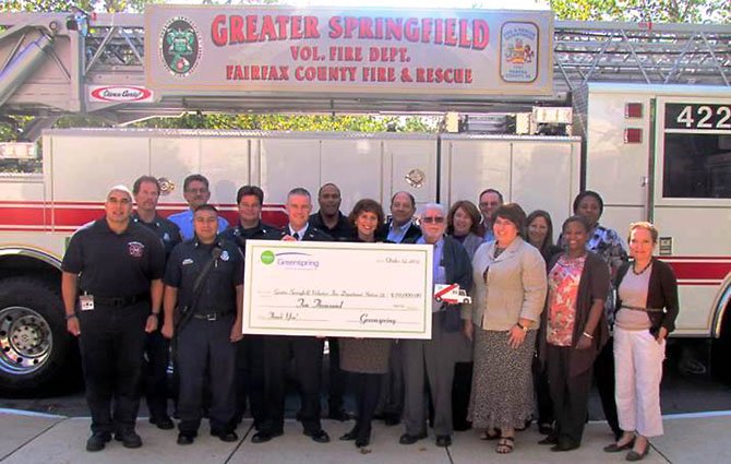 (From left) Station 22 Firefighters Sergio Nava, Mark Huehn, Rick Machado, Luis Mata, Bobby Bookwalter, Fire Chief Blake Payne; Greenspring staff members Ken Roland, Executive Director Robin Gliboff, Berwick Drews, resident Bill Campbell, Kimberly Nelson, resident Roy O’Connor, Lynn Keefe, Holly Borrero, Tamika Mitchell, Karen Boyce, Lee Long. Resident Bill Campbell, holding a small medic truck, made the truck at Greenspring’s woodshop and presented it to the Station 22 Firefighters.