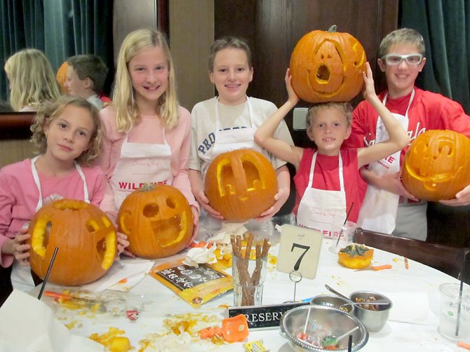 Vienna children donned their chef’s aprons and clowned around with their carved pumpkins during Saturday’s pumpkin-carving workshop and contest at Wildfire in McLean. (From left) Ashton Cain, 9; Elizabeth Kuhlkin, 9; Ransom Cain, 12, Preston Cain, 9, and Patrick Kuhlkin, 11. A portion of the proceeds from the event benefits Food for Others in Fairfax.