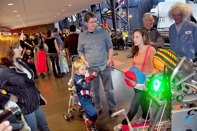 Megan Labery, a senior on the Herndon High School Robotics team, demonstrates the team’s latest robot t
the Udvar-Hazy Center Saturday, Oct. 27. 