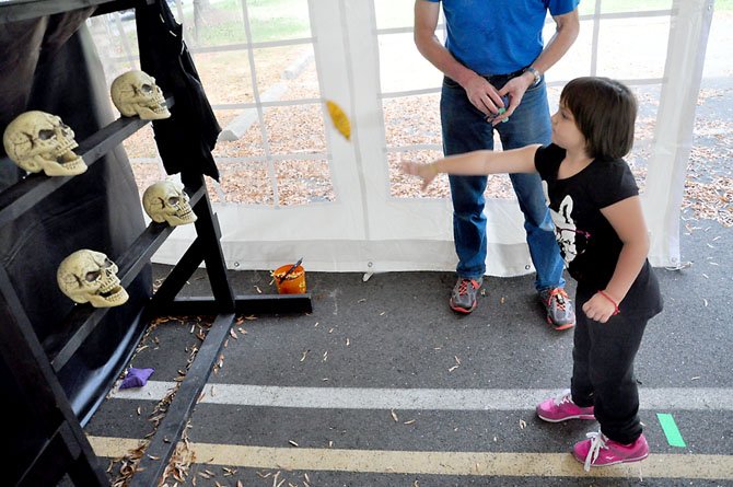 Jamie Whiting, 4, practices the skull toss at the Bradley Farm Haunted House Saturday, Oct. 27.