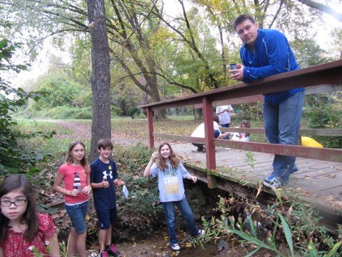 Churchill Road fifth graders in Bob Timke's science class collect water samples in Dead Run Creek. From left are Katherine Dunne, Diana Liddell, Jake Yates, Maggie Snyder and fifth grade teacher Bob Timke.