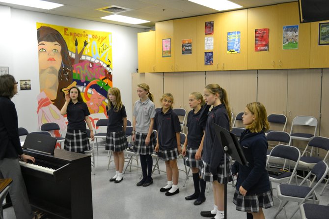 The sixth grade chorus class, including students Kiley Hatch, Maddy Conroy, Lily James, Julia Cipollone, Emma Pelletier, Caroline Dauchess and Grace Talbott, practice one of their more challenging pieces, Laudate Dominum.