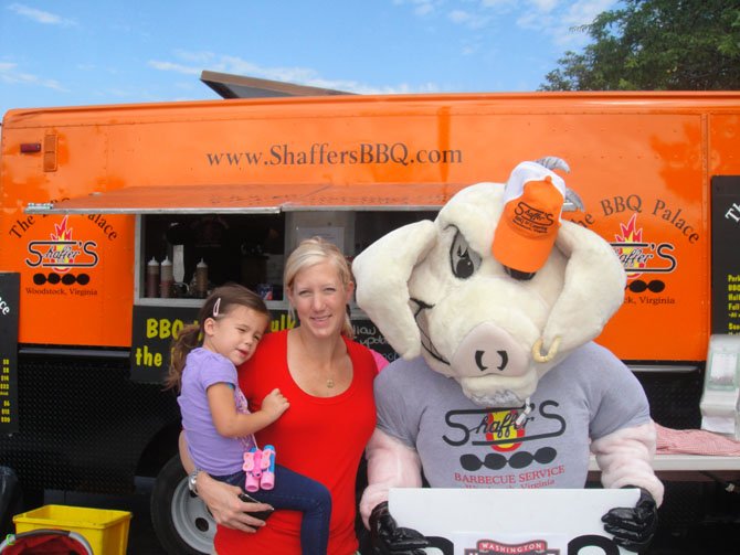 Arlington residents Meghan Latcovich, Maddie Latcovich, and the Duke of Pork enjoy sizzling BBQ sandwiches at Shaffer’s BBQ Palace.

