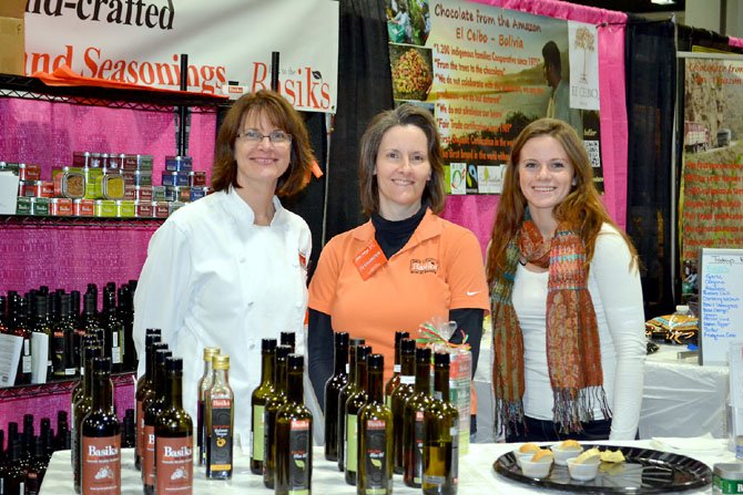 Anne Shomberg (left) of Basiks at Home, in Reston, pictured with her daughter Amy Shomberg and sister-in-law Tamra Mehlberg (center), shares her spices, seasonings, vinegars and oils with visitors at the 2012 Metropolitan Cooking and Entertaining Show in Washington.