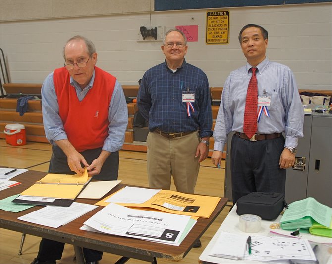 (From left) Precinct 324 election officials have it under control at Herndon Middle School: Dan Linder, Walter Hadlock, and Chief Election Officer Chen Yang.