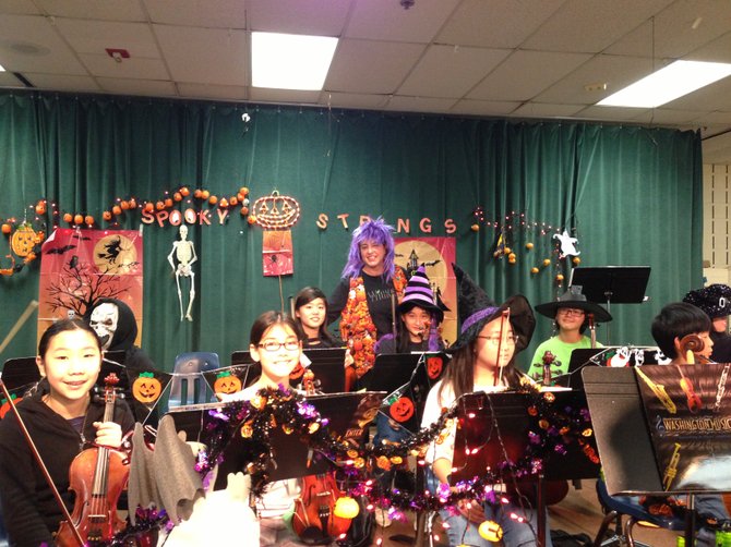 The Ghoulish Gang performs spooky strings tunes for White Oaks Elementary School in Burke on Wednesday, Oct. 31.