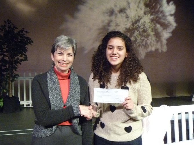 ennifer Levy, the McLean Community Players chair, presenting the $200 award check to Sofia Padilla, winner of McLean Community Players’ “Last Summer” essay-writing contest.