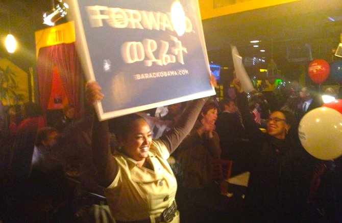 Alexandria resident Rediet Melesse celebrates the Democratic sweep at the Alley Cat Restaurant and Lounge in the city’s West End.