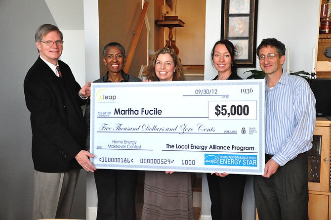 From left, Michael Sanio of the Reston Association Board of Directors, Supervisor Cathy Hudgins (D-Hunter Mill), homeowner Marti Fucile, Cynthia Adams of the Local Energy Alliance Program, and homeowner Eric Shor. Fucile and Shor were awarded $5,000 to make their Lake Audubon townhouse more energy efficient. 