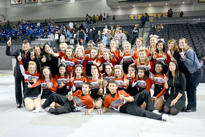 Herndon Varsity Co-Ed Cheer with the Virginia States Championship trophy. Back Row: Coach Deven Song, Coach Suzanne Mansfield, Coach Jenny Goff, Conlan Miller, Veronica Wood, Briana Heckard, Breana McPherson, Lexia Rowley, Lisa Sheffer, Bridget Nagy, Claire Barnes, Rebecca Valley, Margaret Schaaf, Macie Heuring, Shannon Kelley, Joanna Albert, Coach Anna Seymour, Coach Emma Collie. Middle Row: Zoe Langendorff, Marissa Foster, Bernadette Abadias, Alex Asack, Sarah Strangfeld, Kara Joyce, Hannah Moore, Meghan Henry, Inteha Hassan, Sheena Okai, Coach Hayden Little. Front Row: Alex Coffelt, Isaac Parada. 
