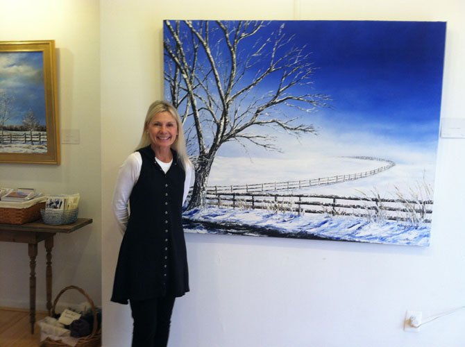 Artist Claire Howard with her painting "A Heavenly Peace."
