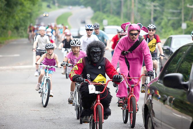 Andrew Steele of Reston—aka “the gorilla”—and Joe Penano of Fairfax Station—aka “the bunny”—helped lead the parade of cyclists down Old Keene Mill Road in Springfield during The Bike Lane’s Relocation Ride last year.  
