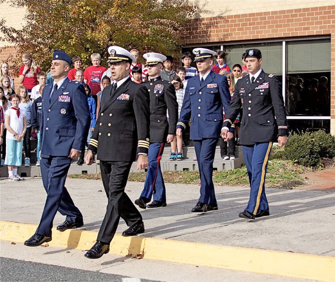 A very special color guard raised the flag at the Sangster Elementary School Veterans Day observance. Officers from all military branches did the honors. Front row, from left, Lt. Col. Jason Pavelschak, US Air Force, Commander Dom Flatt, US Navy. Back row, Major Brian Mahler, US Marine Corps, Lt. Michael Whitredge, Coast Guard, and Major Luke Karnes, US Army.
