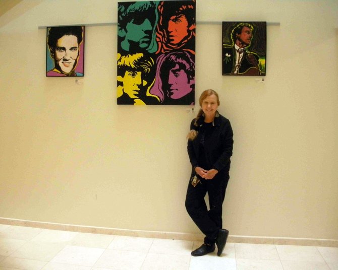 Artist Rosemary Gallick has paintings on exhibition in three locations this month. She is shown here with her paintings at the Reston Association. Gallick teaches art history at Northern Virginia Community College.