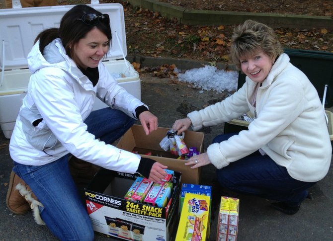 Pictured, from left, CWCA party organizer, Julie Schwan, and the past president of CWCA, Catherine Blakely. Chesterbrook Woods Citizen's Association donated more than 80 pounds of leftover food and beverages from its annual fall party to local food pantry, SHARE of McLean www.shareofmclean.org.

