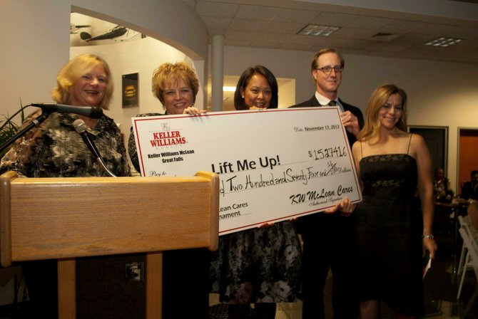 From left, Karen Briscoe, a Lift Me Up! board member and principal Realtor® of the Huckaby Briscoe Conroy Realty Group; Kay Bellhouse, the team leader for the McLean-Great Falls Keller Williams offices; MJ Perry, co-chair of the golf tournament and a Realtor®; Derek Blain, one of the co-principals of the McLean-Great Falls KW office; Jennifer Lucier, the president of Lift Me Up! The check was presented at the Lift Me Up! ‘A Magical Night’ Gala at BMW of Sterling on Saturday, Nov. 17.
