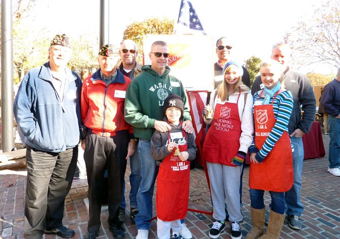 Salvation Army board chairman Walter Clarke (back, second from right), joins volunteers from American Legion Post 24 in Market Square Nov. 17. as part of the annual Red Kettle Campaign. Pictured are: (back) Jim Glassman, Henry Dorton, John Bordner, Jim Lindsay, Clarke and Eric Eide. In front are Mark, Lisa and Caroline Lindsay.
