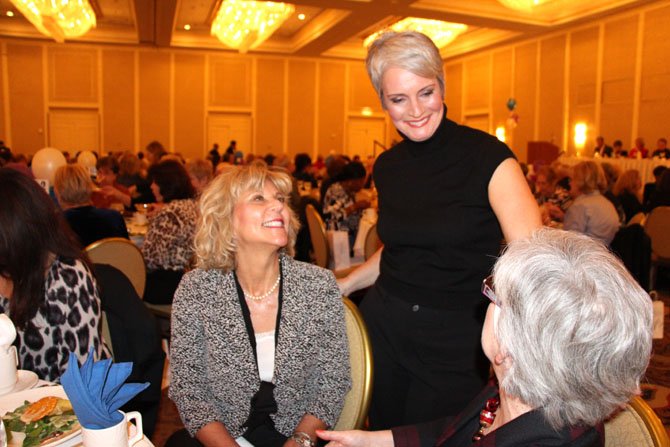 Member of the Board of Lady Managers Jane Hughes says hello to Janet Barnett and Suzanne Kratzok before hitting the runway in the fashion show.
