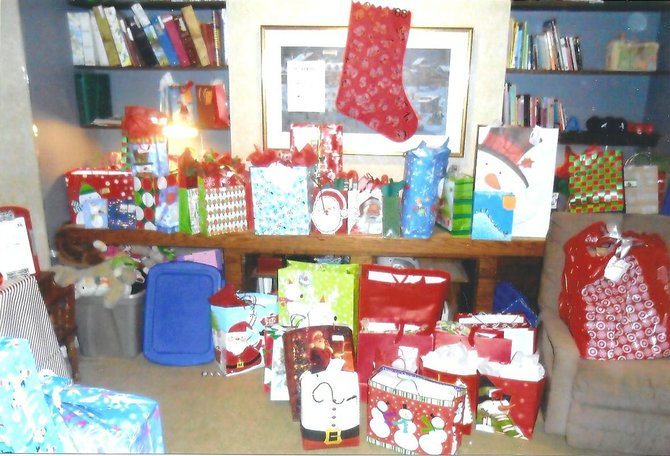 Gifts are brought to Ginger Mahon's house on the day of the donation drive in December of 2011.