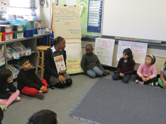 Ms. Jane Cofie-Raczko gives her first grade class the details regarding their upcoming test.