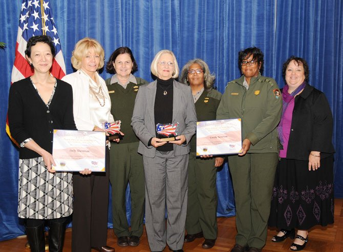 At the Department of Interior's National Volunteer Award presentation, from left, are Rhea Suh, Assistant Secretary of Interior; Judy Sherman, award winner; Donna Cuttone, National Park Service ranger; Sandy Newton, award winner; Delphine Gross, National Park Service ranger; Jacqueline Davis, National Park Service ranger, and Lisa Young, Department of the Interior program specialist.
