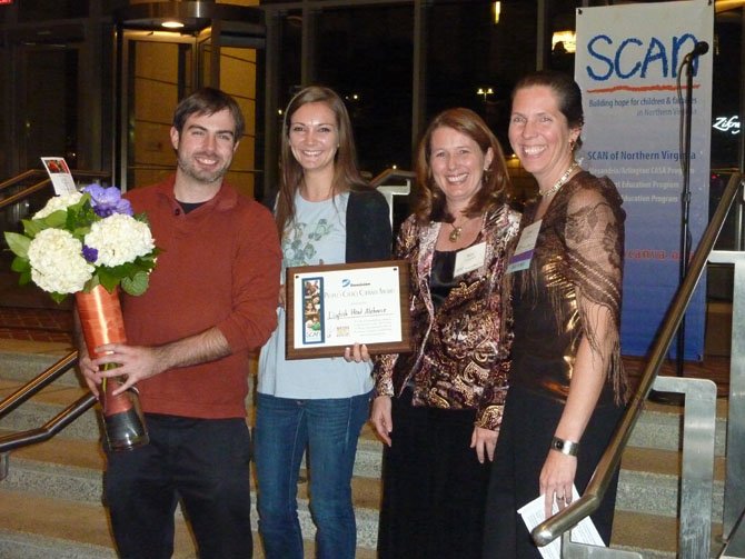 Dave Davies and Elizabeth Harmon of Dogfish Head Ale House receive the evening's culinary award from Dominion Power's Kimberly Campbell and SCAN executive director Sonia Quinonez.