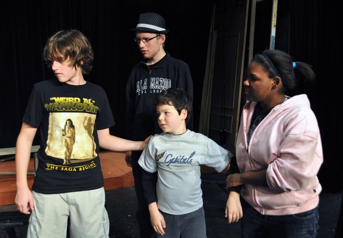 From left, Blake Phillips as Ralph Herdman, Ryan Clark as Leroy Herdman, Brendan Dure as Charlie Bradley, and Jody Parker as Imogene Herdman in rehearsal for the Providence Players of Fairfax production of “The Best Christmas Pageant Ever.”