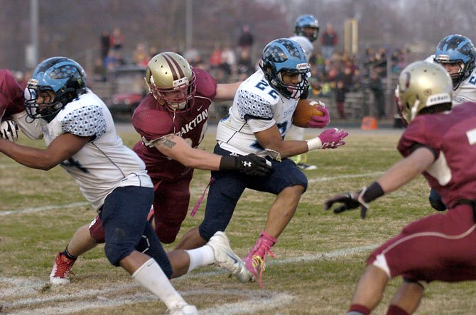 Oakton defensive lineman Joe Allely reaches for L.C. Bird running back Paul Robertson during the Division 6 AAA state football semifinals on Saturday, Dec. 1 at Oakton High School.