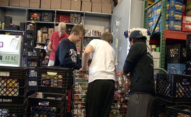 Volunteers organize the food shelves at the Arlington Food Assistance Center.