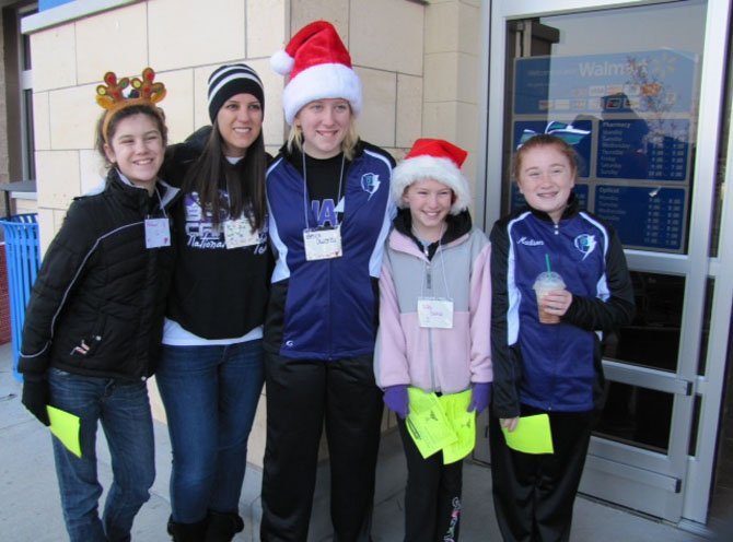 From left are Rebecca Gallagher, Joy Hansen, Becca Owens, Kelly Domas and Madison O'Neill of Phase Cheer & Dance outside the Fair Lakes Walmart.